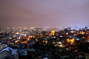View on roofs in the city of Dalat. Da Lat and the surrounding area is a popular tourist destination of Asia. City with fogs and mountains photo