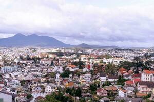 View on roofs in the city of Dalat. Da Lat and the surrounding area is a popular tourist destination of Asia. City with fogs and mountains photo