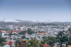 View on roofs in the city of Dalat. Da Lat and the surrounding area is a popular tourist destination of Asia. City with fogs and mountains photo