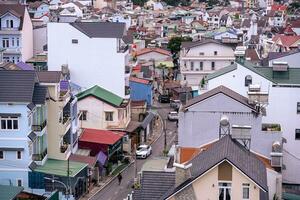 View on roofs in the city of Dalat. Da Lat and the surrounding area is a popular tourist destination of Asia. City with fogs and mountains photo