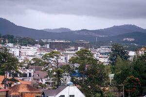 View on roofs in the city of Dalat. Da Lat and the surrounding area is a popular tourist destination of Asia. City with fogs and mountains photo