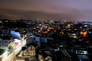 View on roofs in the city of Dalat. Da Lat and the surrounding area is a popular tourist destination of Asia. City with fogs and mountains photo