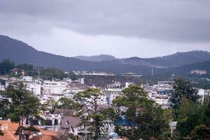 View on roofs in the city of Dalat. Da Lat and the surrounding area is a popular tourist destination of Asia. City with fogs and mountains photo