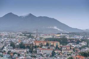 View on roofs in the city of Dalat. Da Lat and the surrounding area is a popular tourist destination of Asia. City with fogs and mountains photo