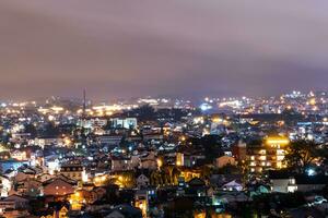 View on roofs in the city of Dalat. Da Lat and the surrounding area is a popular tourist destination of Asia. City with fogs and mountains photo