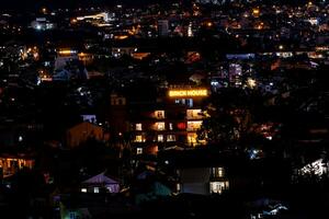 View on roofs in the city of Dalat. Da Lat and the surrounding area is a popular tourist destination of Asia. City with fogs and mountains photo