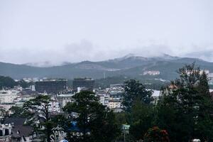 View on roofs in the city of Dalat. Da Lat and the surrounding area is a popular tourist destination of Asia. City with fogs and mountains photo