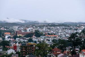 View on roofs in the city of Dalat. Da Lat and the surrounding area is a popular tourist destination of Asia. City with fogs and mountains photo