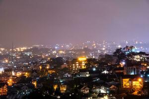 View on roofs in the city of Dalat. Da Lat and the surrounding area is a popular tourist destination of Asia. City with fogs and mountains photo