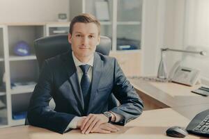 Confident businessman at desk in a sleek office photo
