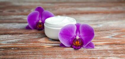 Jar of anti-aging face cream on wooden background. Facial skin care. Natural skincare cosmetics. Close-up. photo