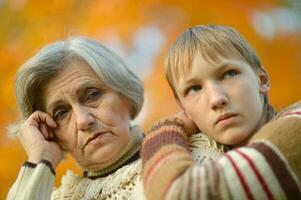 Sad Grandmother with boy in the park photo