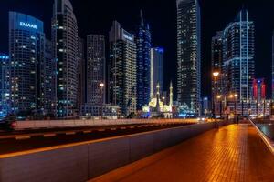 Dubai, United Arab Emirates - March 12, 2023-View of Dubai skyscrapers while walking at Dubai Marina during a night. photo