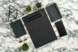 Top view in focus with different office equipment, supplies, stationery. Marble table with copy space. Education, workplace background. Close-up. photo