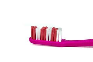 Pink toothbrush on white background photo