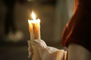 Beautiful image of a Nazarene and his candle in procession photo