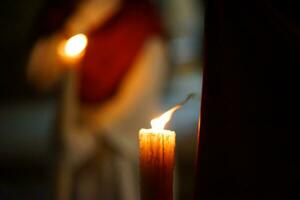 Closeup of a Nazarene and his candle in procession photo