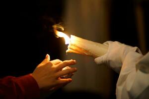 close-up of a child's hands asking a Nazarene for wax photo