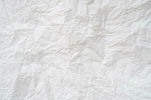 Wrinkled or crumpled white stencil paper or tissue after use in toilet or restroom with large copy space used for background texture in decorative art work photo