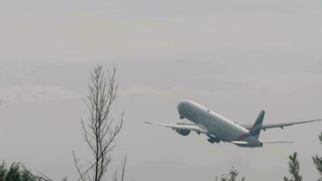 PHUKET, THAILAND - JANUARY 31, 2023. Boeing 777 of Emirates taking off and climbing at Phuket airport. Flight departure video