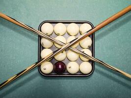 Billiards, billiard table, balls and cue. Balls in the tray and photo