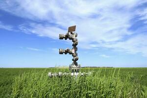 Canned oil well against the sky and field photo