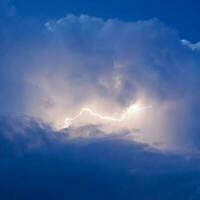 Lightnings in storm clouds. Peals of a thunder and the sparkling photo