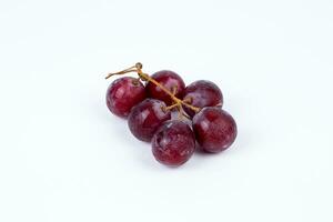 Red fresh grapes isolated on white background photo