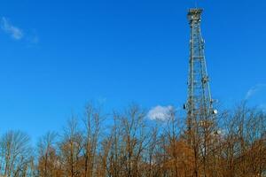 image of communication mobile internet antenna over blue sky background photo