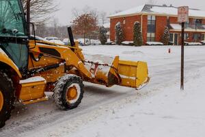 Snow plow doing removal after a blizzard photo