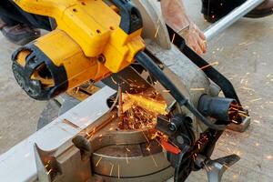 Worker grinding a metal plate photo