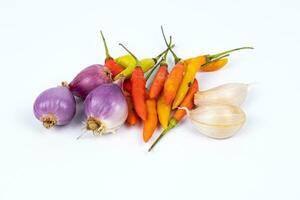 chili,curly chili, Onion garlic, and shallots isolated on a white background photo