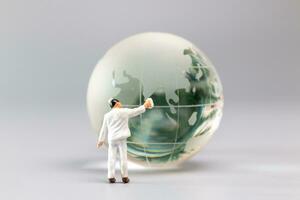 Painters are polishing a crystal globe, and the concept of World Earth Day photo