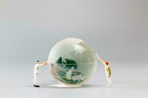 Painters are polishing a crystal globe, and the concept of World Earth Day photo