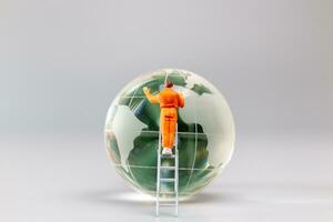 Painters are polishing a crystal globe, and the concept of World Earth Day photo