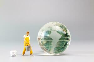 Painters are polishing a crystal globe, and the concept of World Earth Day photo