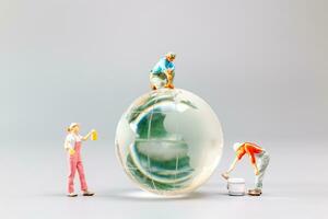 Painters are polishing a crystal globe, and the concept of World Earth Day photo