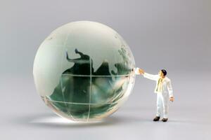 Painters are polishing a crystal globe, and the concept of World Earth Day photo