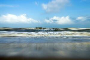 Motion image of running on the beach into the sea. photo