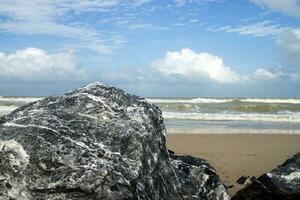 Black and white stone on the beach. photo