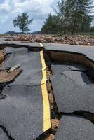 Road erosion caused by waves and severe storms. photo