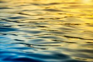 Reflective of blue water surface with sunlight. photo