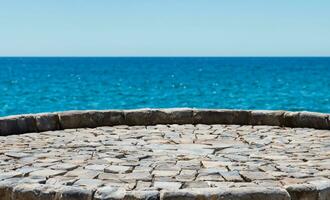 AI generated a stone bench sitting on top of a wall overlooking the ocean photo