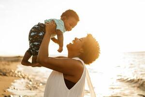 A proud mother with her newborn baby in the beach. photo