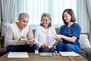 Senior couple get medical service visit from caregiver nurse at home while explaining on doses of vitamins and drug pill for health care and pension welfare insurance photo