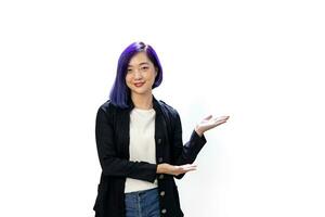 Portrait of young Asian LGBTQ freelance designer businesswoman in formal cloth with dyed blue hair presenting with hand gesture isolated on white background for business people photo