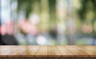 Empty wooden table top with lights bokeh on blur restaurant background. photo