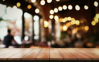 Empty wooden table top with lights bokeh on blur restaurant background. photo