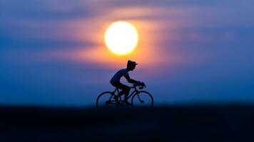 Silhouettes cyclists on the beach at sunset. photo