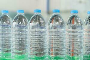 Closeup on mineral water bottles in raw and lines photo